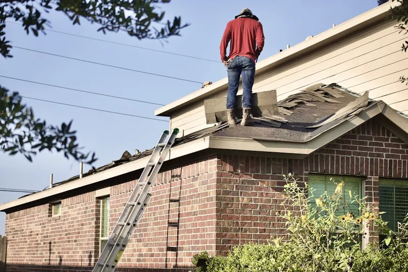 Professional roofer working on a residential roof in Sand Lake